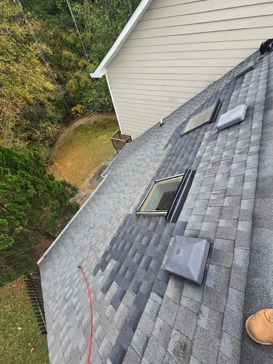Roof window area with finished shingles after repair